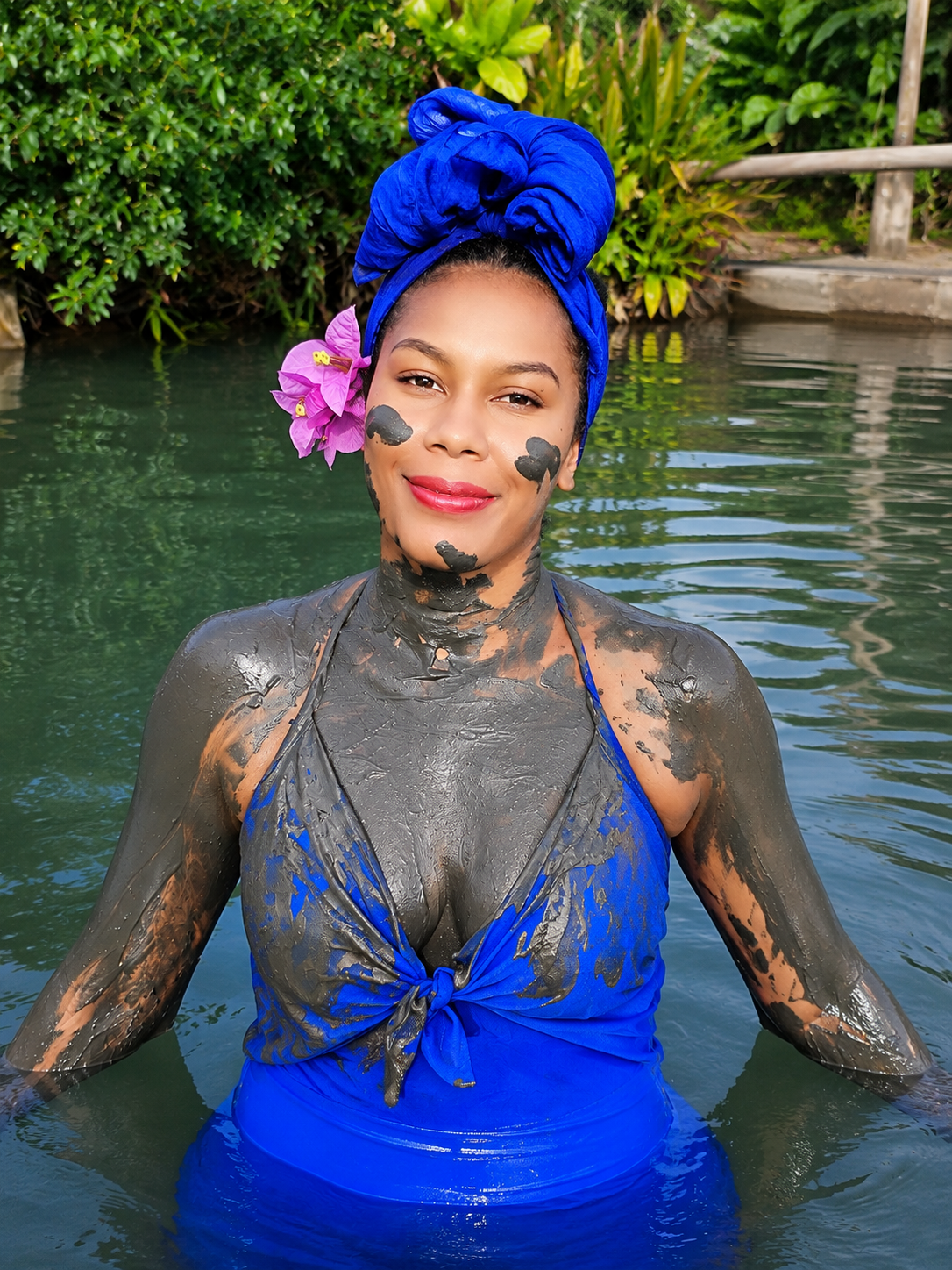 Travellers laughing while covered in grey mud at Fijian mud pools and hot springs